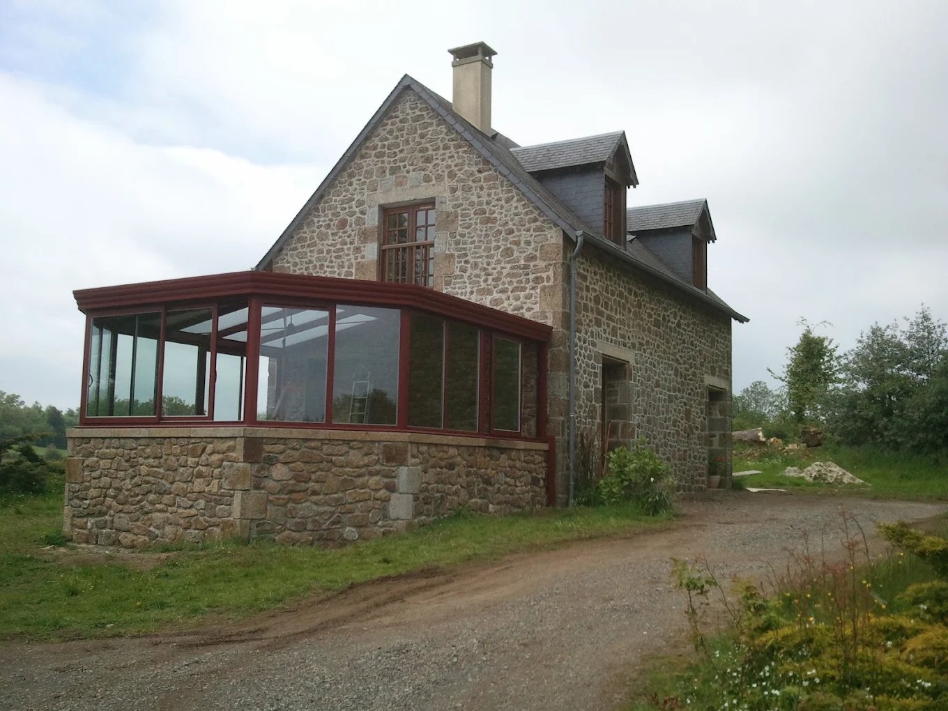Véranda aluminium sur maison en pierre normande
